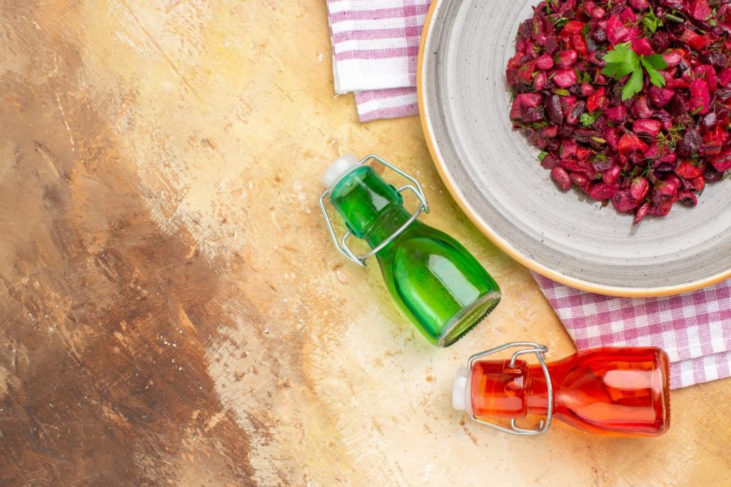 top view Appetizing salad aesthetic oil bottles and free space for words